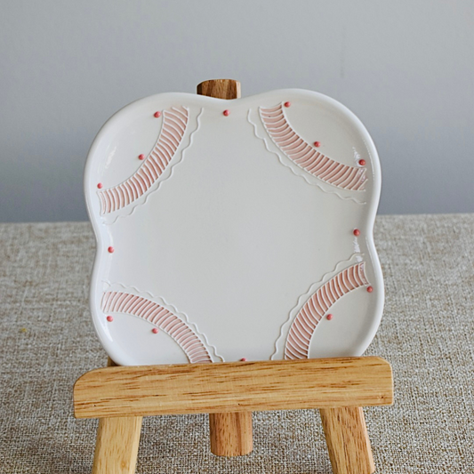 A beautifully crafted 3D Underglazed Ceramic plate with delicate pink patterns and textured edges