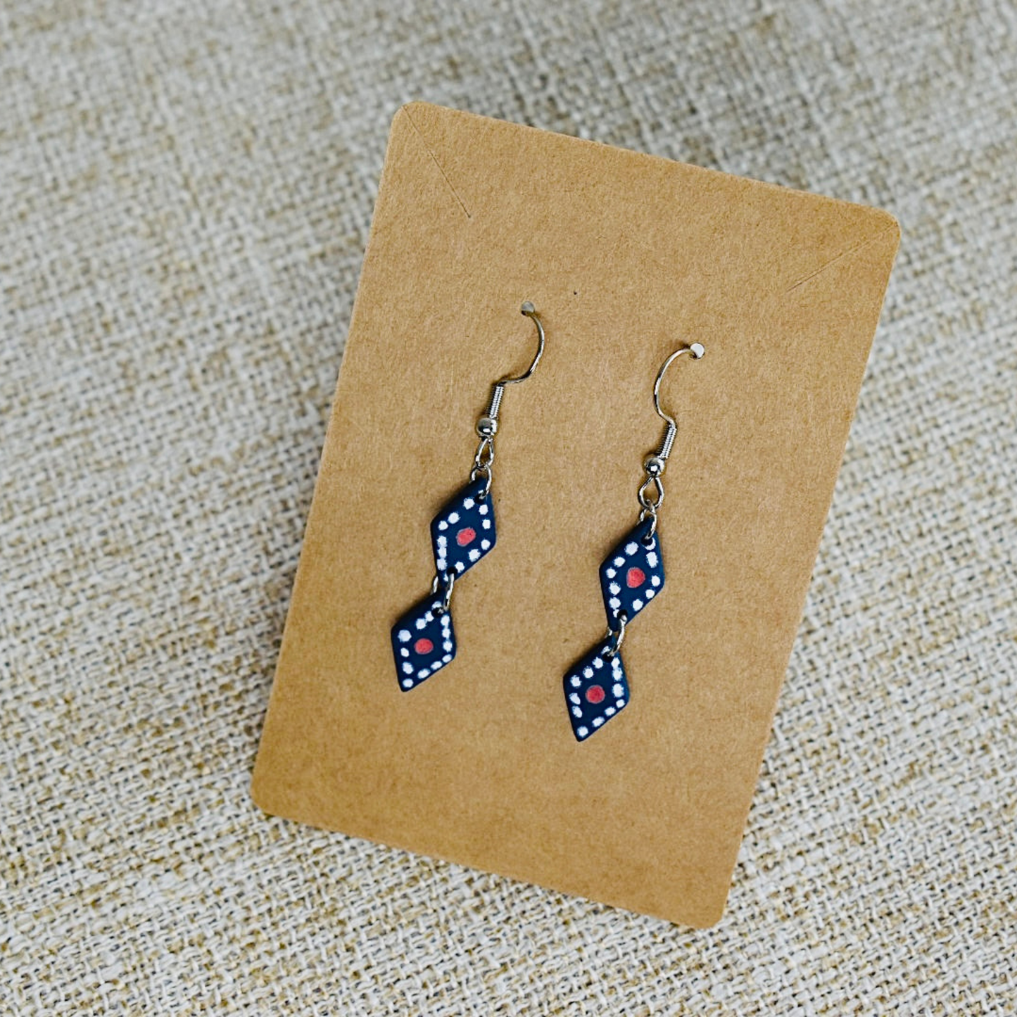 Handmade polymer clay earrings featuring a unique blue and red diamond pattern design